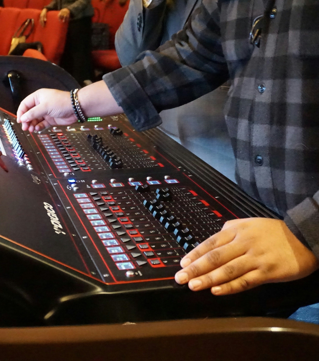 Person Mixing Audio on a Console